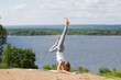 © ulza - Woman wearing yoga clothes practicing yoga  and does a handstand on a sunny summer day in nature. Healthy and sport lifestyle. Fitness sport girl  doing gymnastics  fitness exercise.