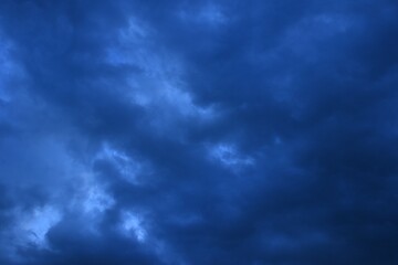 Wall Mural - dark rain cloud floating on sky at sunset in evening