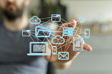 Leinwandbilder - man interacts with a digital network, showcasing cloud storage, file sharing, and data synchronizati