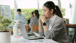 © ChayTee - Asia people young adult woman bad day work hard bored data tired at office desk workplace think worry job tough stress asian workforce issue. Mid life crisis mental health illness sad labor effort.