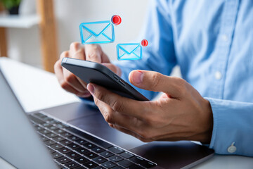 Poster - Person checking emails on smartphone near laptop computer