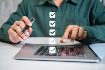 Poster - Person completing online checklist on laptop computer