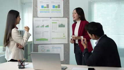 Aufkleber - Focused asian businesswomen presenting infographic charts, collaborating with businessman in modern office setting, analyzing strategic data and discussing project insights