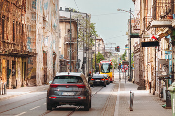 Naklejka na meble Urban street under renovation with cars and tram in European city