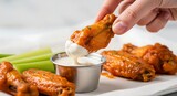 Close-up of Buffalo Wings Dipped in Creamy Ranch Dressing
