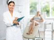 © JackF - Young woman cosmetologist in uniform makes notes in medical room