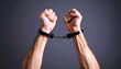 © intricateflow - A Powerful Close-Up of Restrained Hands in Metal Handcuffs, Symbolizing Justice, Control, and Tension Under Dramatic Lighting — A Cinematic Glimpse into Law Enforcement and Consequence