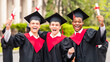 © Prostock-studio - Positive guys students posing together next to university, wearing graduation costumes and showing diplomas. Cheerful multiracial group of male friends celebrating graduation, portrait