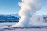 Majestic geyser erupts steam against snowy mountain range winter wonderland