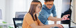 © Urbanscape - Asian male, female programming developer work together at home office, brainstorm discussion. Information technology, software engineer programmer coding job, man woman coworker teamwork. Copy space