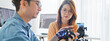 © Urbanscape - Asian male, female programming developer work together at home office, coding robotic arm machine. Information technology, software engineer programmer job, man woman coworker teamwork concept