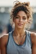 © Oleksandr Pashchenko - A woman with curly hair wearing a gray tank top