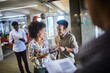 © Geber86 - Happy business colleagues using a tablet for a presentation in a modern office