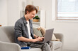 © Pixel-Shot - Teenage boy with laptop working online at home