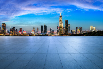 Wall Mural - empty square floor and illuminated city skyline with modern commercial buildings at night in shenzhe