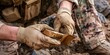© bborriss - Soldier opening military food ration package during operation
