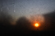 © faithie - sunrise through fogged up window with droplets and silhouettes of trees and houses