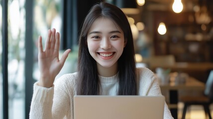 Poster - Young woman greeting with a smile while sitting at a laptop in a cozy cafe setting