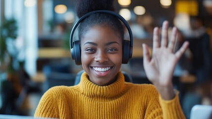 Poster - Smiling woman waves hello while working on laptop in a modern workspace