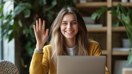 Poster - Smiling woman waves hello while working on her laptop in a cozy indoor space