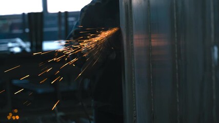 Poster - Grinding metal with a pneumatic tool creates sparks in the workshop