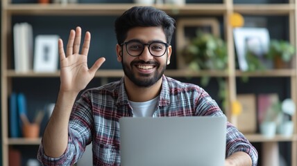 Poster - Person waving hello while using a laptop in a modern workspace filled with greenery and books