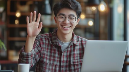 Poster - Young person waves hello while working on a laptop in a modern cafe setting during daytime