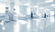 © al-sultan - Blurred hospital interior with beds equipment and people walking in a bright setting.
