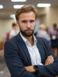 © Mykhailo - Confident Professional Man in Business Attire with Arms Crossed at Conference or Meeting