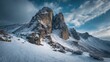 © Lasvu - A snow-covered rocky mountain in winter under the blue cloudy sky
