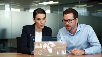 Poster - Business Professionals Analyze Data On Transparent Screen Display In a Modern Office Interior With Glass Wall