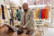 © ReeldealHD images - Man Working on Laptop in Fashion Retail store
