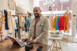 © ReeldealHD images - Boutique store owner using a laptop computer