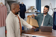 © ReeldealHD images - Customer making contactless payment at clothing store