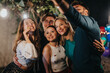 © qunica.com - Group of friends sharing a happy moment, socializing and celebrating during an evening event outdoors.