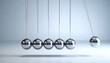 © Igor_Tichonow - Newton's cradle demonstrates physics concept of conservation of momentum and energy, symbolizing cause-effect, innovation, or workplace productivity themes