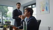 © stockbusters - Serious intern typing computer corporate office closeup. Mentor helping manager