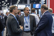 © Pavel - Business executives engaged in discussion during a networking event in a convention center aiming to foster collaboration and innovation among industry leaders in mid-2023
