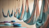 Fabric-covered hanging hammocks designed for meditation and aerial yoga practice.