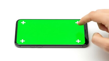 Hand touching green screen smartphone