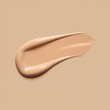 © CoralFox - Close up of liquid foundation smear on a flat beige background. Makeup sample texture for beauty advertisement or cosmetic product test banner or poster.