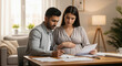 © Vasiliy - Pregnant woman and man reviewing documents at home table. Family planning maternity insurance healthcare financial consultation prenatal care expecting baby