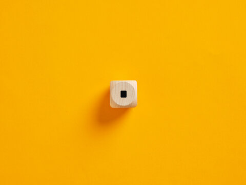 Wooden cube showing minus sign on vibrant background