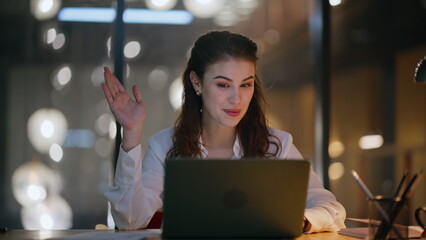 Poster - Late worker video calling by laptop in business office closeup. Smiling woman
