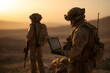 © utaem2022 - Soldiers using laptop during military operation at sunset in the desert
