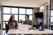 © Wavebreak Media - Asian and diverse women collaborating on laptop in modern office