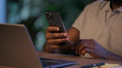 African American business man hands holding mobile phone scrolling gadget online work businessman in office night evening male employer smartphone message internet web network using app cropped view