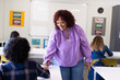 © Wavebreak Media - In school, female teacher engaging with diverse students, smiling and creating positive environment