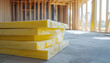 © Oleksiy - Insulation material stack in new house construction. Beige fiber panel provides thermal acoustic comfort. Building site, house frame, window, ready for renovation
