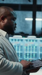 Poster - Vertical video Manager overseeing server room, walking around with checklist on laptop, troubleshooting hardware. Supervisor doing inspection in server hub, overseeing infrastructure performance